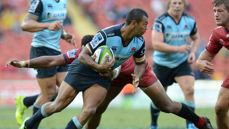 Kurtley Beale of the Waratahs attempts to break away from the Reds defence 