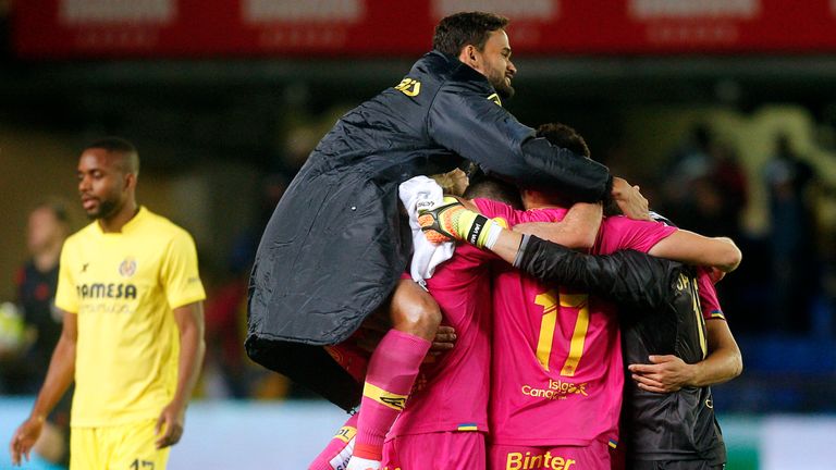 Las Palmas' players celebrate their victory at the end of the Spanish league football match Villarreal CF 