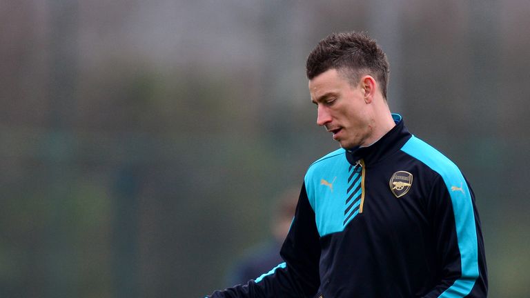 ST ALBANS, ENGLAND - MARCH 15:  Laurent Koscielny of Arsenal passes a ball during a training session ahead of the UEFA Champions League round of 16 second 