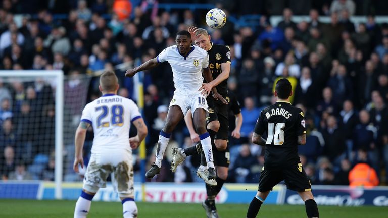 Mustapha Carayol of Leeds and Dean Moxey of Bolton Wanderers FC comepte for the ball.
