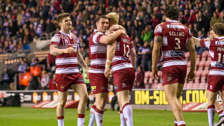 Wigan's Matty Smith congratulates Liam Farrell on scoring a try against Widnes
