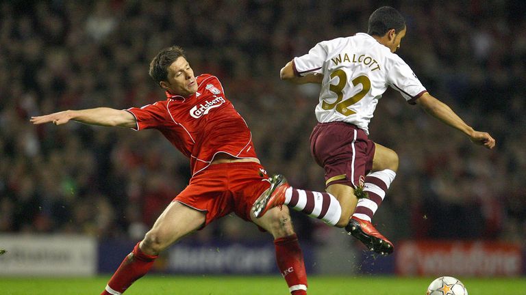 Xabi Alonso tackles Theo Walcott during a Champions League meeting in 2008