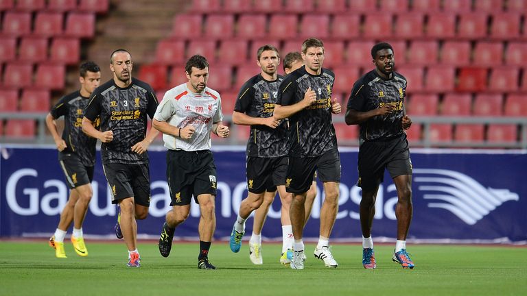 Morgans jogs alongside Steven Gerrard, Kolo Toure and other Liverpool players