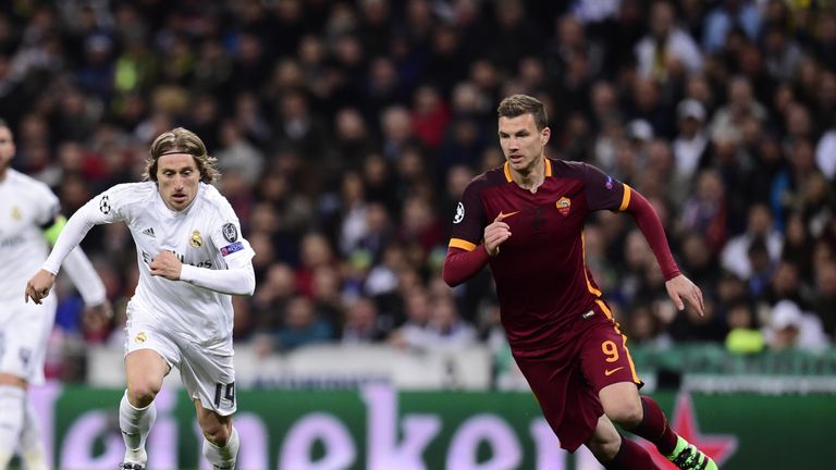 Real Madrid's Luka Modric (L) vies with Roma's Edin Dzeko