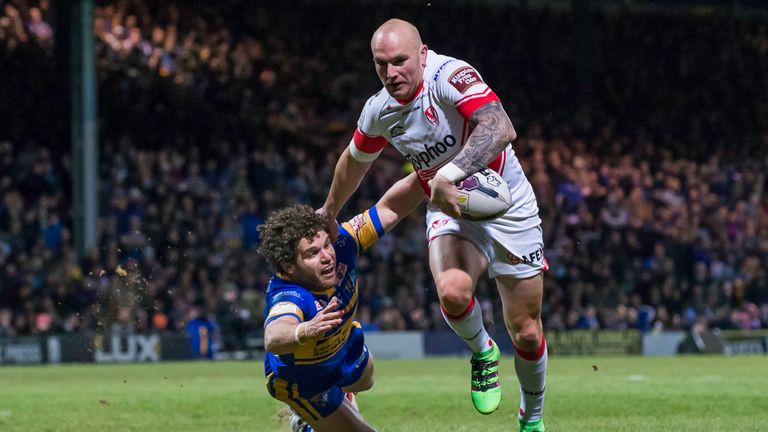 St Helens' Luke Walsh fends off Leeds' Beau Faloon on his way to scoring a try.