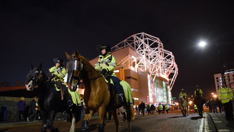Mounted police personnel patrol outside Old Trafford 