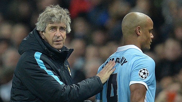 Manuel Pellegrini (L) consoles Vincent Kompany