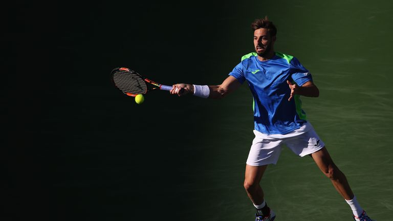 INDIAN WELLS, CA - MARCH 12:  Marcel Granollers of Spain returns a shot against Andy Murray of Great Britain during the BNP Paribas Open at the Indian Well