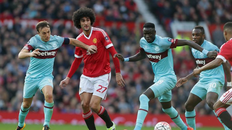 Marouane Fellaini of Manchester United in action with Mark Noble of West Ham United