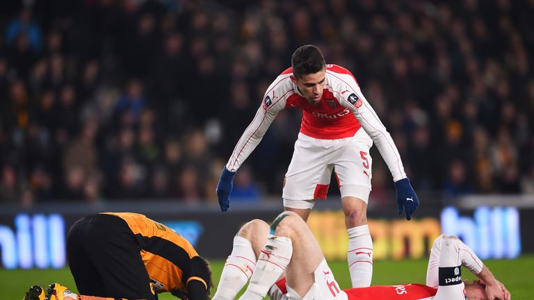 Gabriel Paulista checks on Per Mertesacker of Arsenal after a clash of heads during the Emirates FA Cup Fifth Round Replay between Hull City and Arsenal