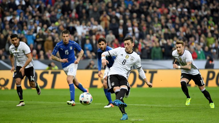 Mesut Oezil of Germany scores his teams fourth goal from the penalty spot during the International Friendly match between Germany and Italy 