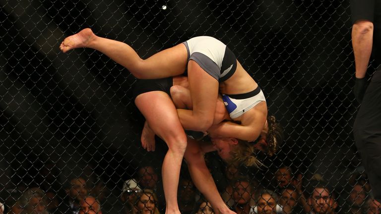 Miesha Tate takes down UFC bantamweight champion Holly Holm during UFC 196 at the MGM Grand Garden Arena on March 5, 2016 in Las