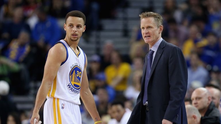 Stephen Curry of the Golden State Warriors talks to head coach Steve Kerr