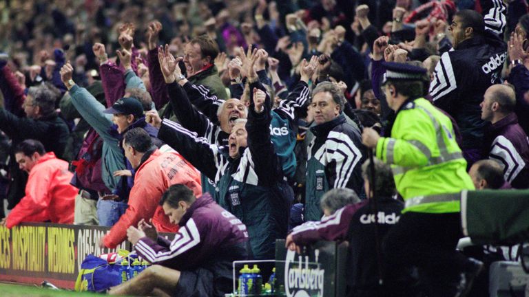 Kevin Keegan can be seen slumped over the advertising hoardings as the Liverpool bench react to Collymore's winning goal