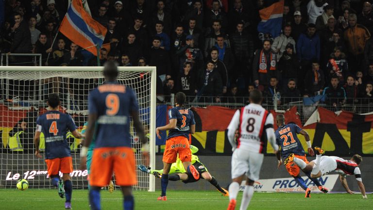Nice's french forward Valere Germain (R) watches after scoring a goal past Montpellier's French goalkeeper Laurent Pionnier (C back)