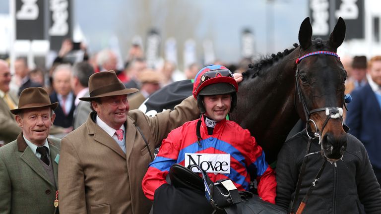Nico de Boinville (centre) celebrates with Trainer Nicky Henderson (second from left) after Sprinter Sacre won the Betway Queen Mother Champion Chase 