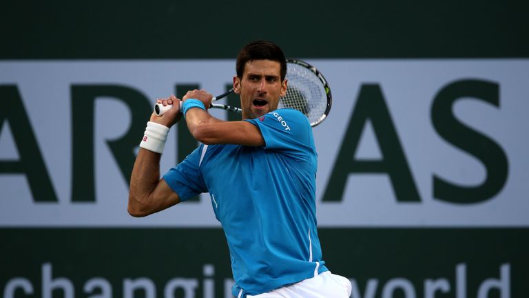 Novak Djokovic of Serbia returns a shot against  Bjorn Fratangelo during the BNP Paribas Open at the Indian Wells Tennis Garden
