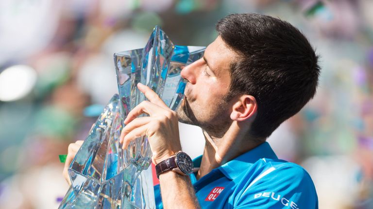 Novak Djokovic kisses the trophy after defeating Milos Raonic at Indian Wells