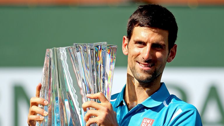 Novak Djokovic poses with the BNP Paribas Open trophy at Indian Wells