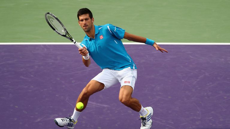 KEY BISCAYNE, FL - MARCH 29:  Novak Djokovic of Serbia plays a forehand volley against Dominic Thiem of Austria in their fourth round match during the Miam