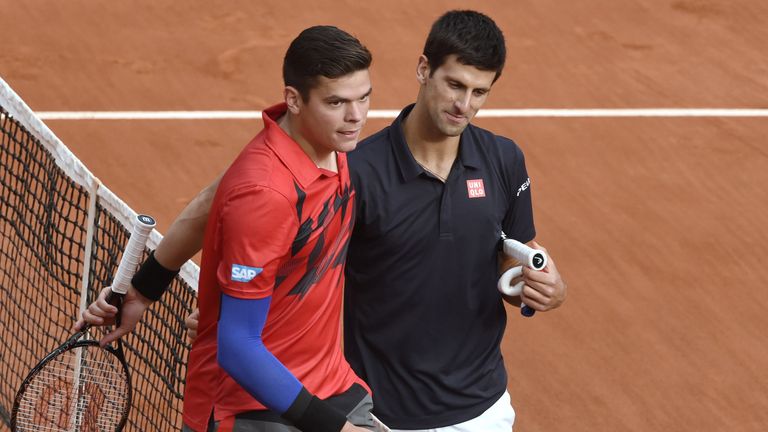 Serbia's Novak Djokovic (R) shakes hands with Canada's Milos Raonic  at the end of their French tennis Open quarter final match againstat the Roland Garros
