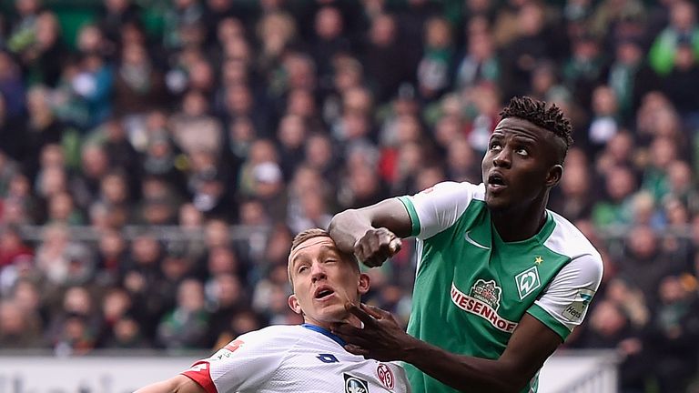 BREMEN, BREMEN - MARCH 19:  Pablo De Blasis of 1. FSV Mainz 05 is pushed down by Papy Djilobodji of Werder Bremen