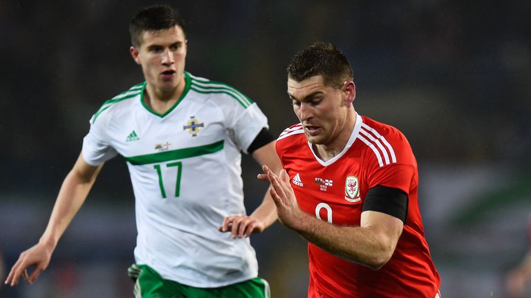 Paddy McNair (l) and Sam Vokes of Wales do battle in Cardiff