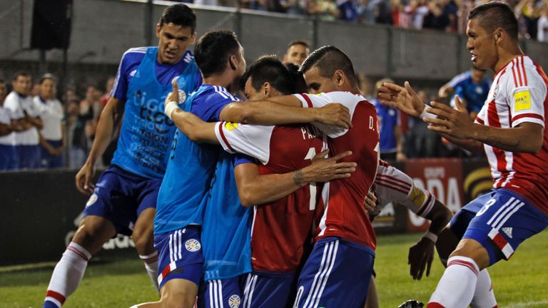 Paraguay's Edgar Benitez [centre] celebrates with teammates after scoring against Brazil