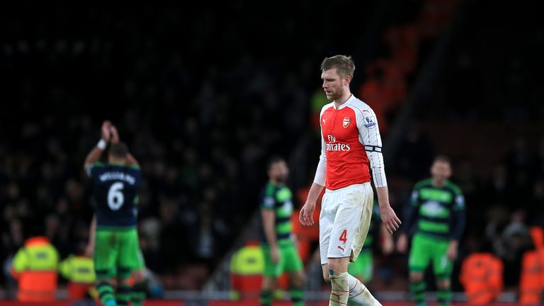 Arsenal's Per Mertesacker is left dejected 