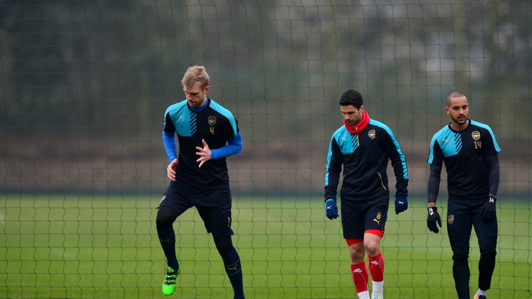 ST ALBANS, ENGLAND - MARCH 15:  (L-R) Per Mertesacker, Mikel Arteta and Theo Walcott of Arsenal take part in a training session ahead of the UEFA Champions