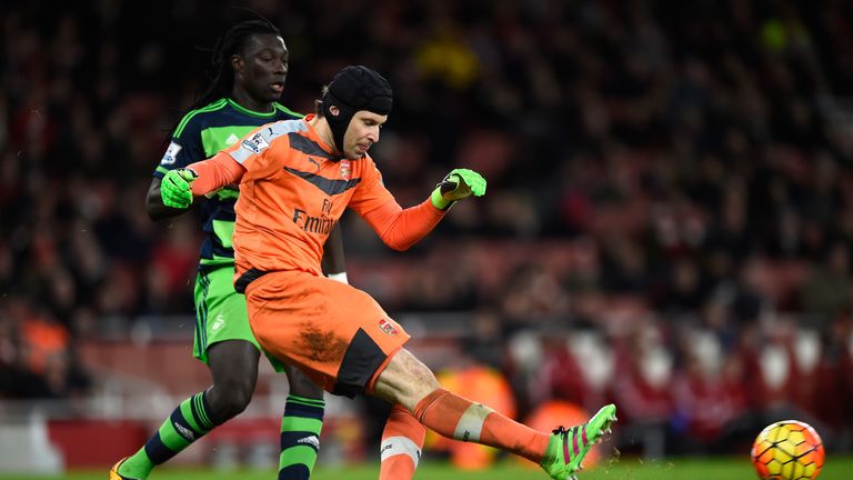 Petr Cech, pictured clearing the ball from Bafetimbi Gomis during Arsenal's defeat to Swansea, will be out for up to a month