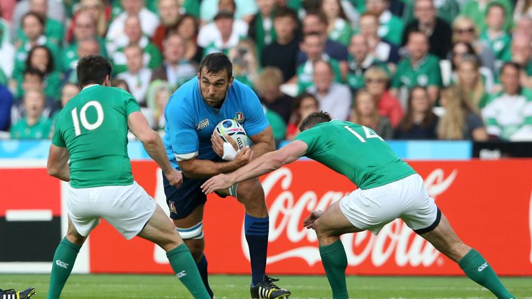 Quintin Geldenhuys (C) of Italy is tackled by Jonathan Sexton (L) and Tommy Bowe (R) of Ireland during the 2015 Rugby World Cup