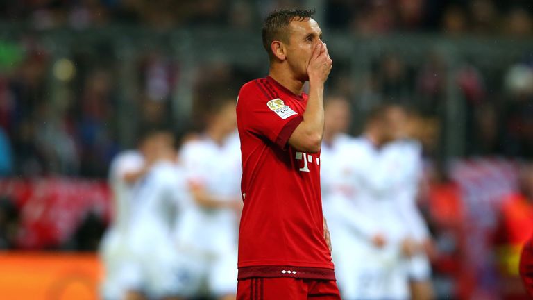 Rafinha of Muenchen reacts after receiving the first goal whilst players of Mainz celebrate during the Bundesliga match between Bayern and Mainz