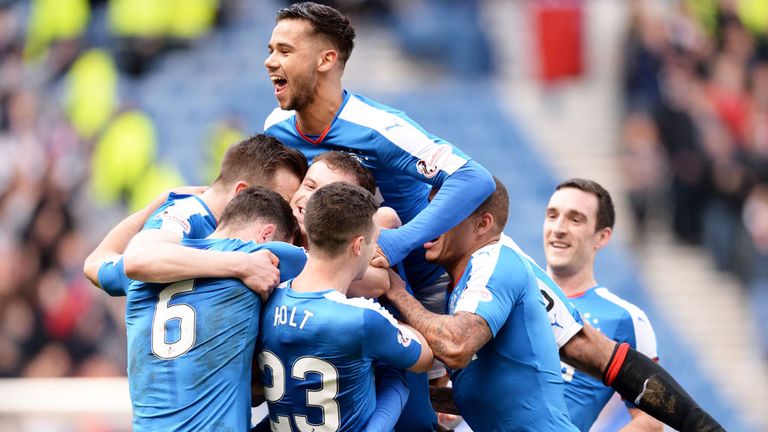 Rangers players celebrate their third goal against Dundee