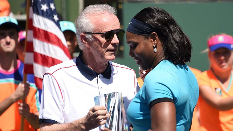 Indian Wells Tennis Garden CEO Raymond Moore (L) presents the second place trophy to Serena Williams of USA after the women's final