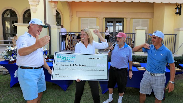 Ernie Els of South Africa holds the cheque with his wife Liezl Els 