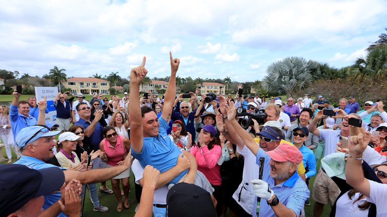 Rickie Fowler of the United States is held aloft by Ernie Els after he had just holed in one in the $1 million Hole-In-