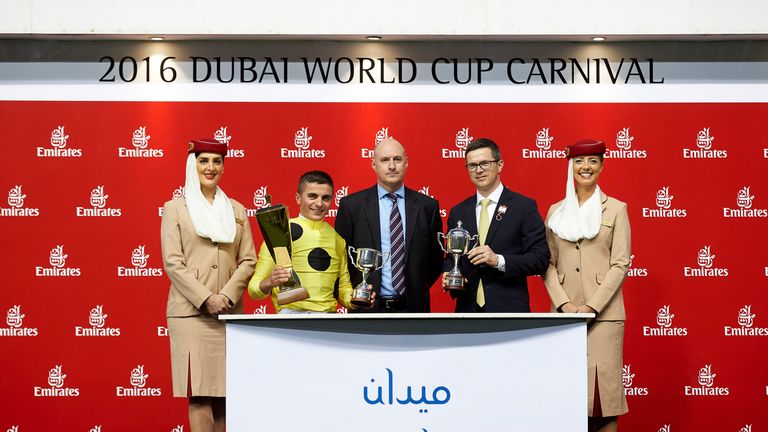 Roger Varian and Andrea Atzeni receive their prizes after the success of Postponed in the Dubai City Of Gold Sponsored by Skycargo. (Dubai Racing Club)