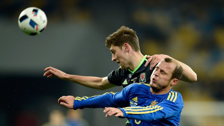 Roman Zozulya of Ukraine and Ben Davies of Wales battle for the ball during the International Friendly match