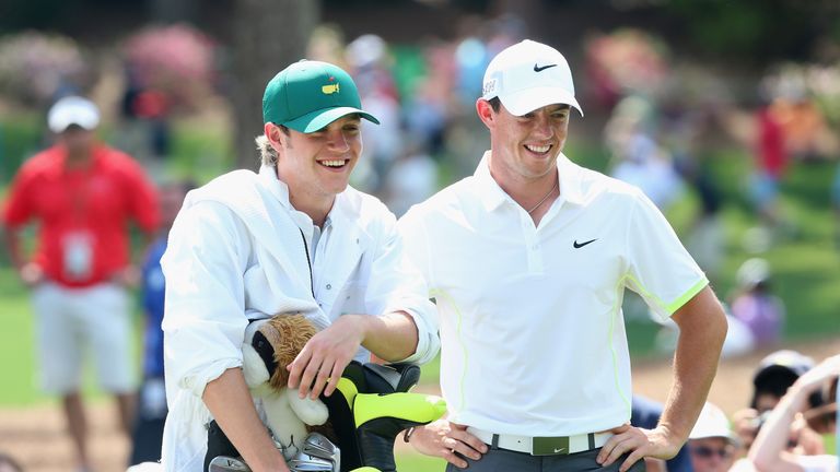 AUGUSTA, GA - APRIL 08:  Rory McIlroy of Northern Ireland waits alongside his caddie Niall Horan of the band One Direction during the Par 3 Contest prior t