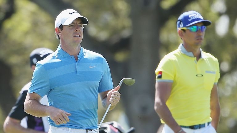 Rory McIlroy of Northern Ireland (L) and Rafa Cabrera-Bello of Spain