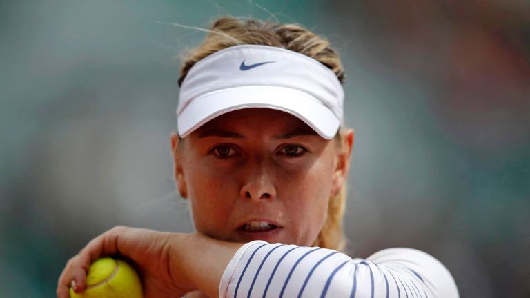 Maria Sharapova of Russia wipes her face during her women's singles match against Lucie Safarova of the Czech Republic during the French Open tennis tournament at the Roland Garros stadium in Paris