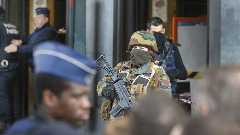 Police control the access to the central train station following bomb attacks in Brussels, Belgium