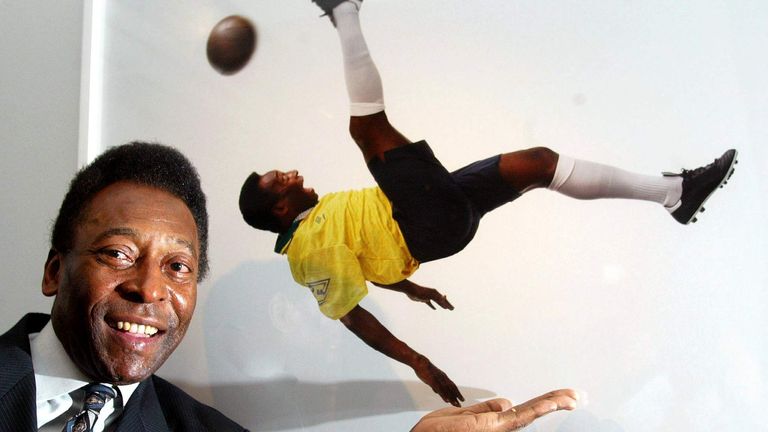 Brazil soccer legend Pele stands next to a photograph of him by Patrick Lichfield at the opening of ..