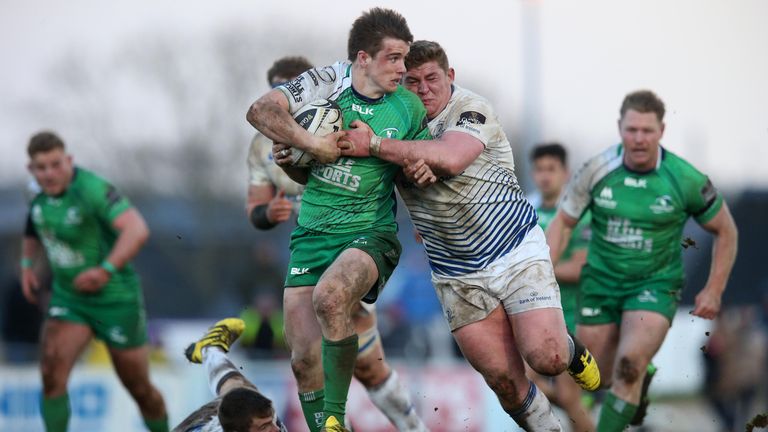 Connacht fly-half AJ MacGinty is tackled by Leinster prop Tadhg Furlong