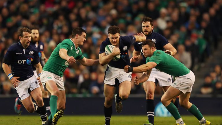 Duncan Taylor is tackled by Jonathan Sexton and Robbie Henshaw of Ireland