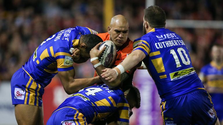 Castleford's Jake Webster is tackled by Leeds' Kallum Watkins, Liam Sutcliffe and Adam Cuthbertson
