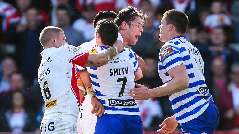 St Helens' Louie McCarthy-Scarsbrook and Wigan's Joel Tomkins clash