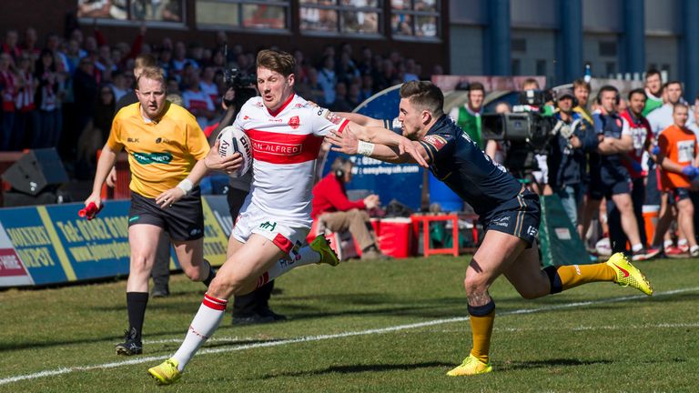 Ryan Shaw fends off Hull FC's Curtis Naughton to score a try