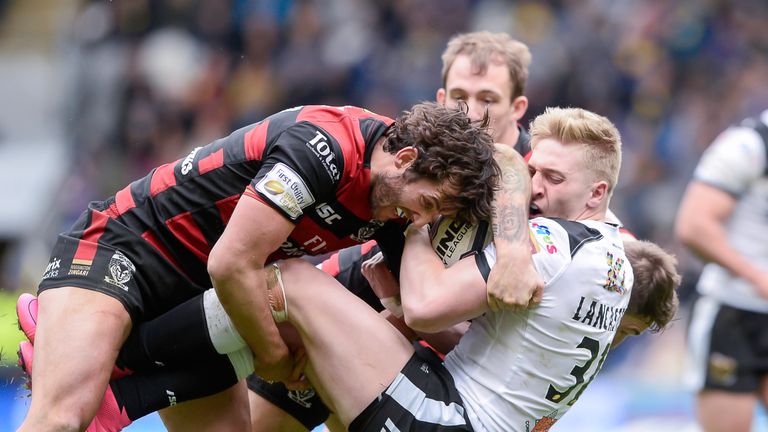 Hull FC's Callum Lancaster is tackled by Warrington's Stefan Ratchford